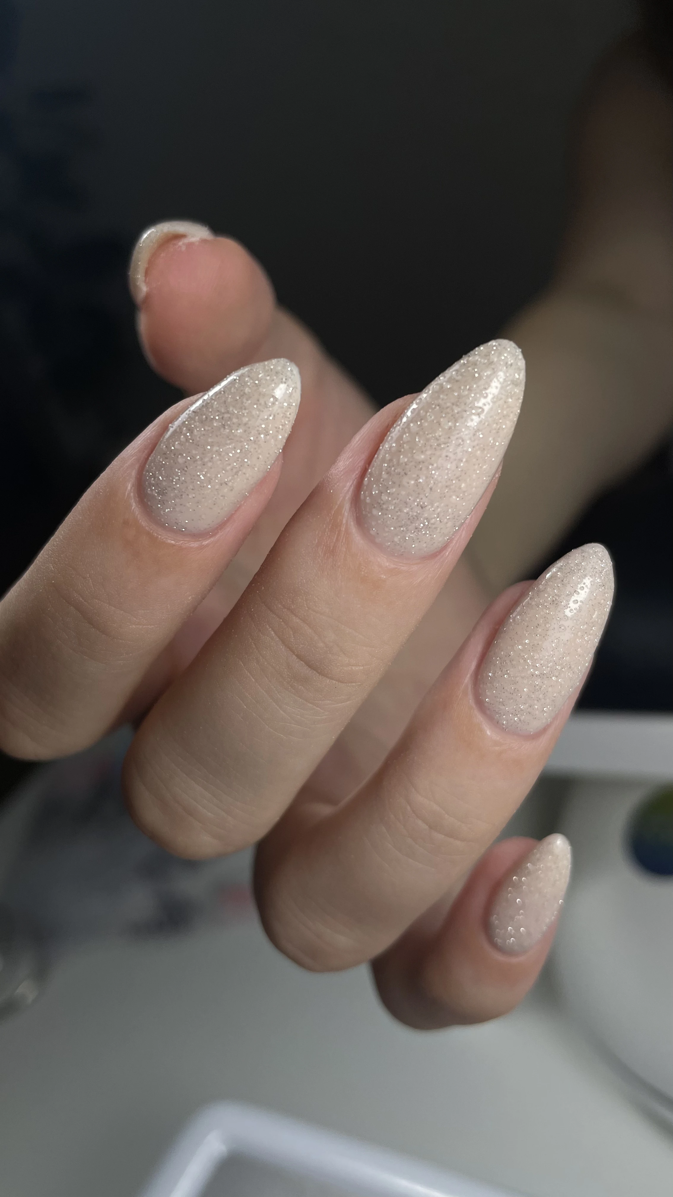 Nail technician performing manicure